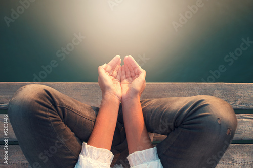 calm woman meditating reciving power by light