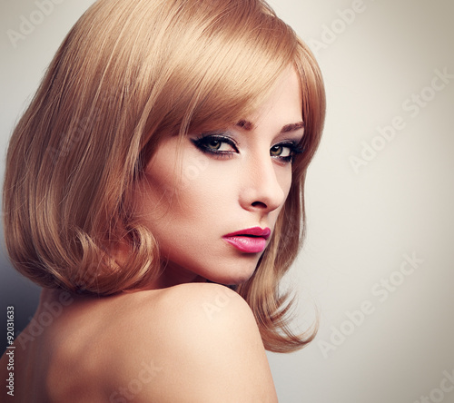 Beautiful female model with fashion blond hairstyle and green ey
