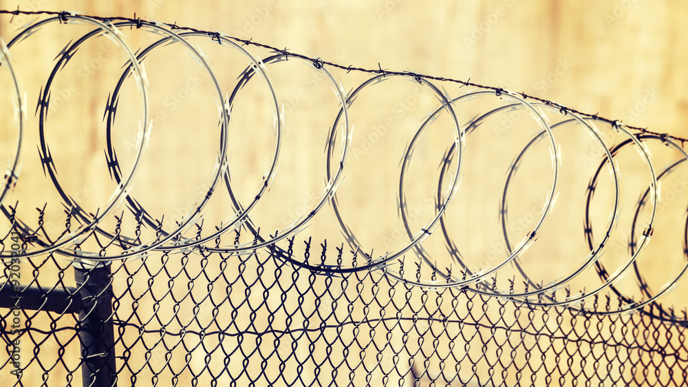 Barbed wire fence, crime and punishment concept photo. Barbed wire fence, crime and punishment concept photo.