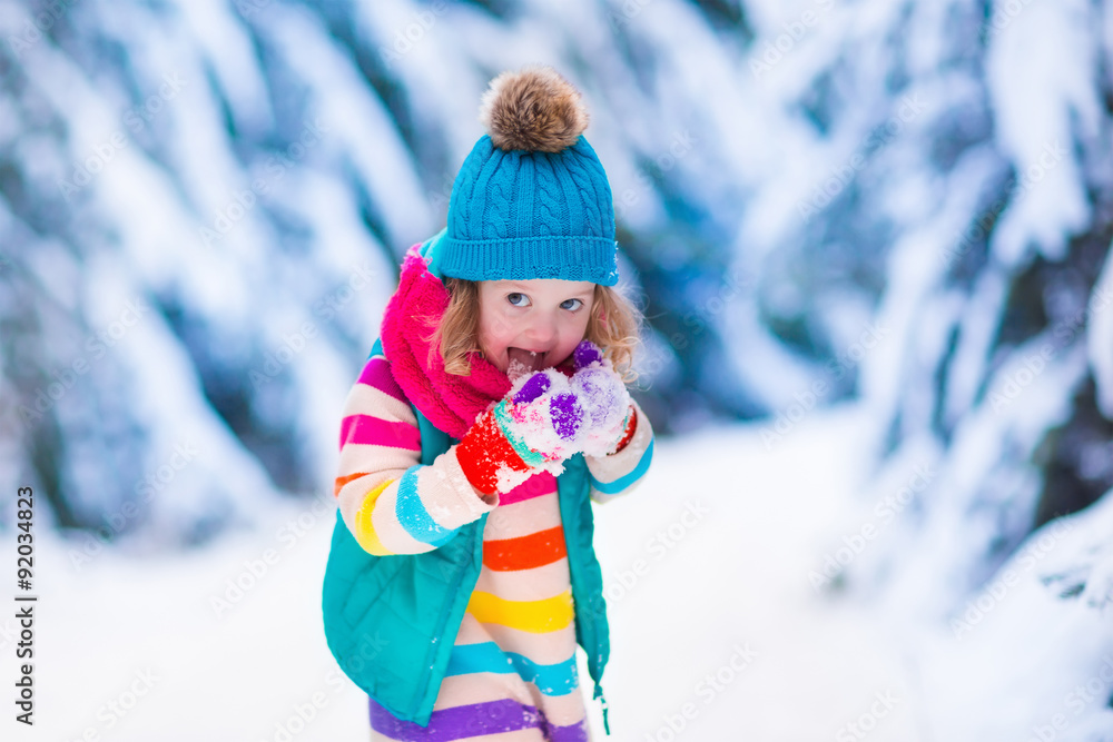 Little girl playing in snowy winter forest Little girl playing in snowy winter forest