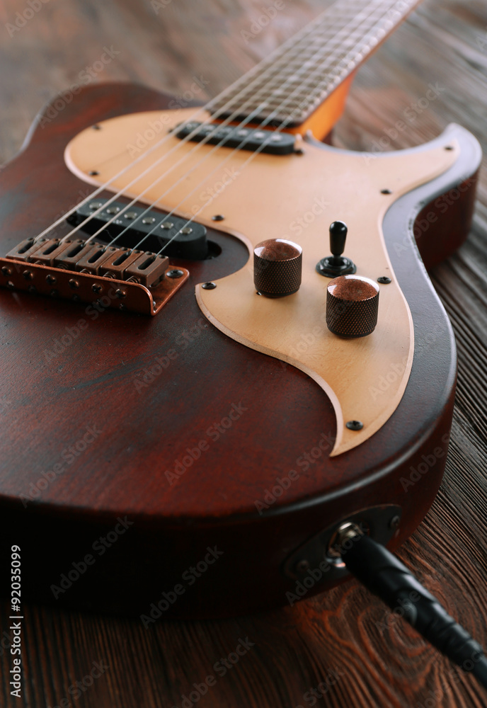 Fototapeta premium Electric guitar on wooden table close up