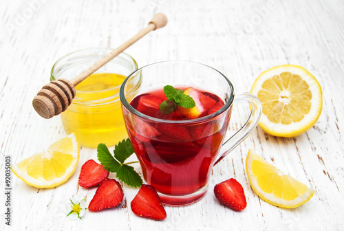 Fruit tea with strawberries, lemon and honey
