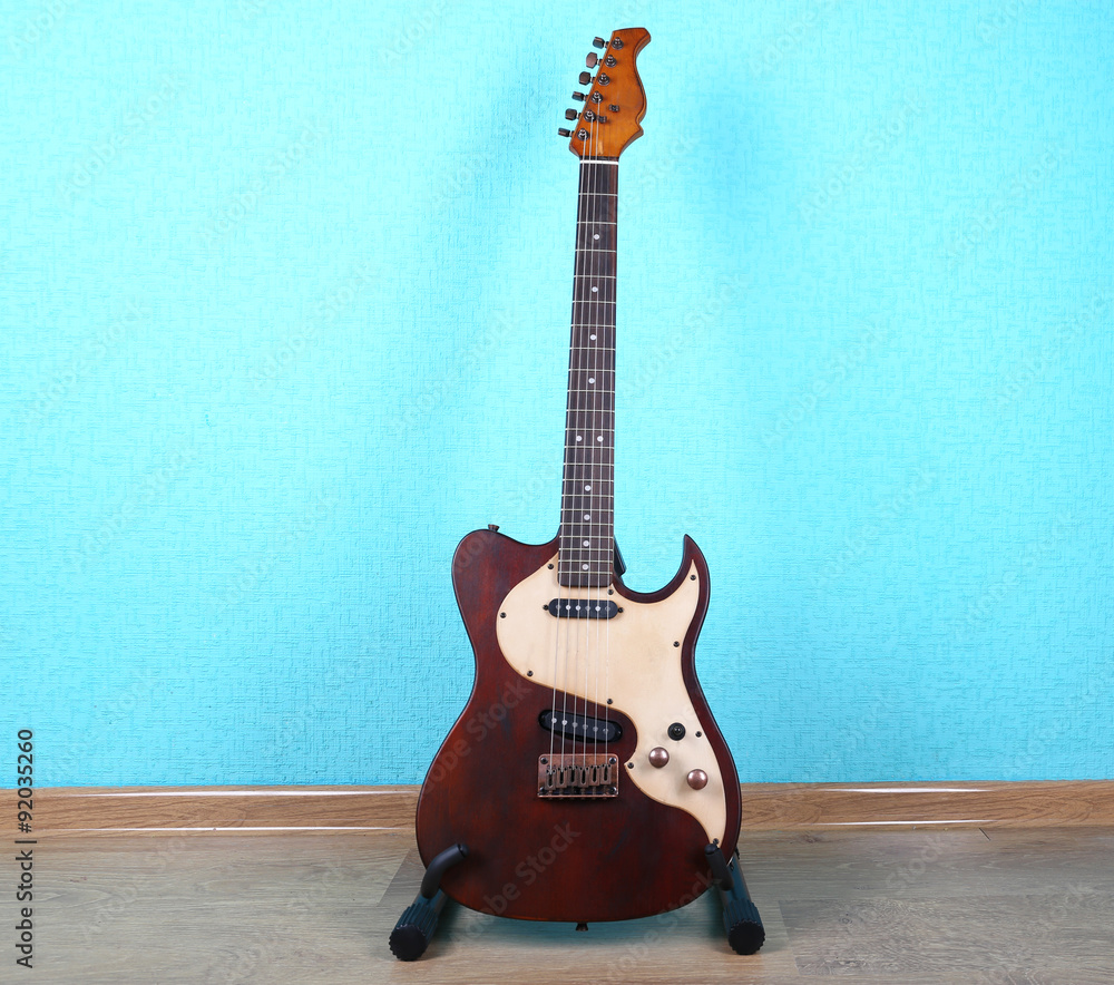 Fototapeta premium Electric guitar on blue wallpaper background