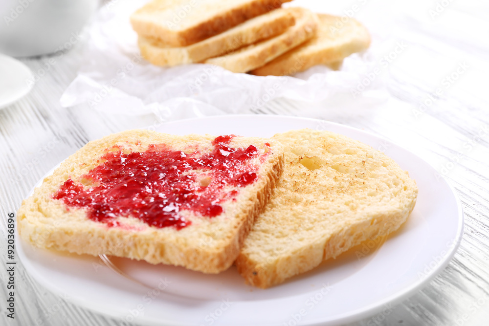 Bread with homemade jam in plate on wooden table, closeup Bread with homemade jam in plate on wooden table, closeup