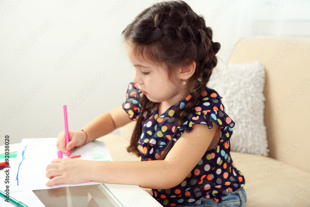 Cute little girl drawing picture on home interior background Cute little girl drawing picture on home interior background