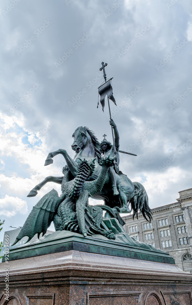 Obraz premium The statue of St. George fighting the dragon in Berlin. It is located on the small square on the waterfront of the Spree. 