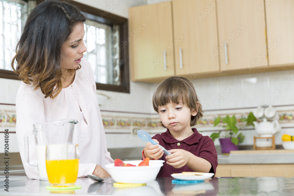 Happy Mother and her boy having breakfast Happy Mother and her boy having breakfast