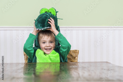 Beautiful child in crocodile costume