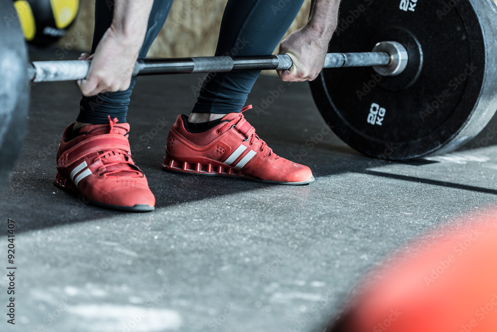 Fototapeta premium Man practicing weight lifting