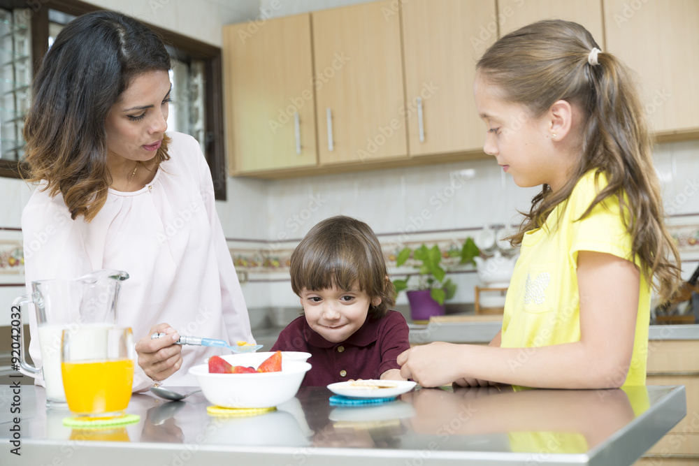 Lovely Mother and her children having breakfast Lovely Mother and her children having breakfast