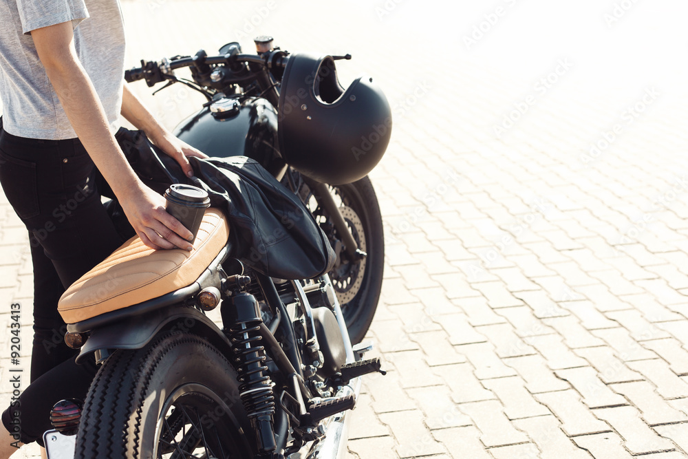 Fototapeta premium girl with cup of coffee and vintage custom motorcycle
