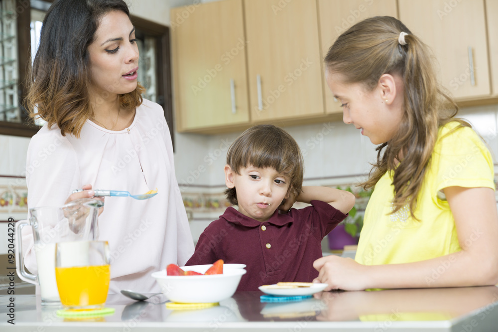 Lovely Mother and her children having breakfast Lovely Mother and her children having breakfast