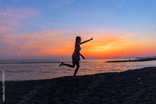 Portrait of beautiful young woman on the beach sunset © idea_studio