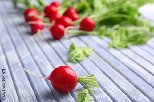 Fresh red radish on wooden table, closeup
