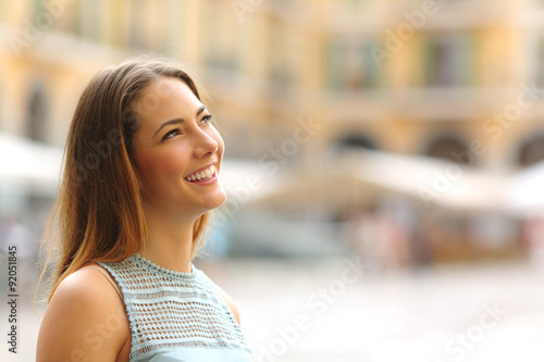Cheerful tourist woman looking at side in a touristic place photo