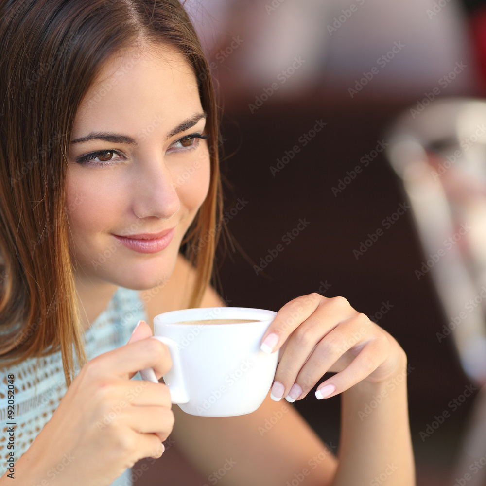 Pensive woman tasting coffee in a restaurant Pensive woman tasting coffee in a restaurant