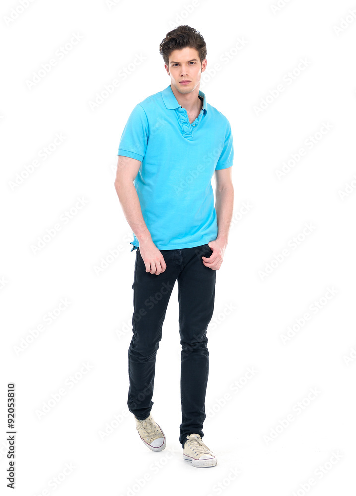 Young man in casual clothes walking in studio over white background. Young man in casual clothes walking in studio over white background.
