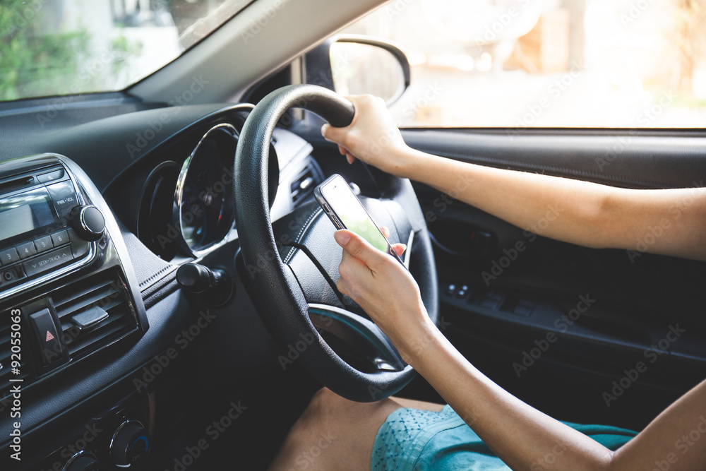 woman driver use her cell phone while driving. Vintage tone