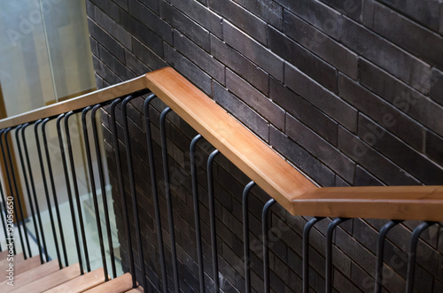 Tela Wooden handrail with brick wall