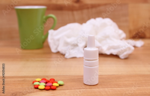 Pills and nose drops for colds, used handkerchiefs and hot tea