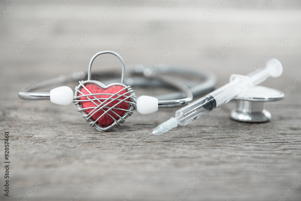 Red heart and a stethoscope on wood background Red heart and a stethoscope on wood background