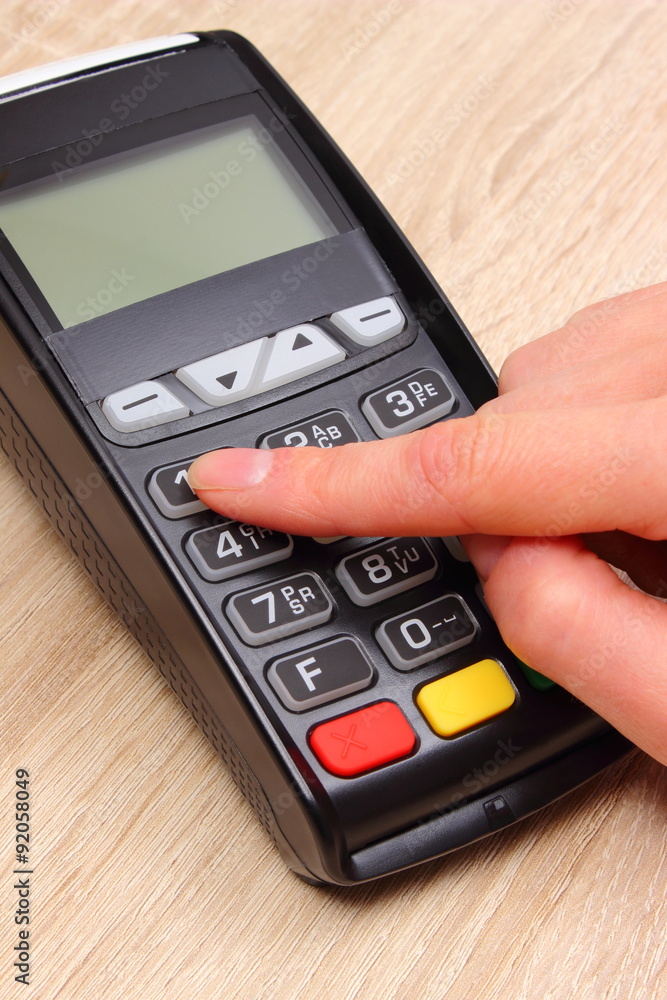Hand of woman using payment terminal, enter personal identification number Hand of woman using payment terminal, enter personal identification number