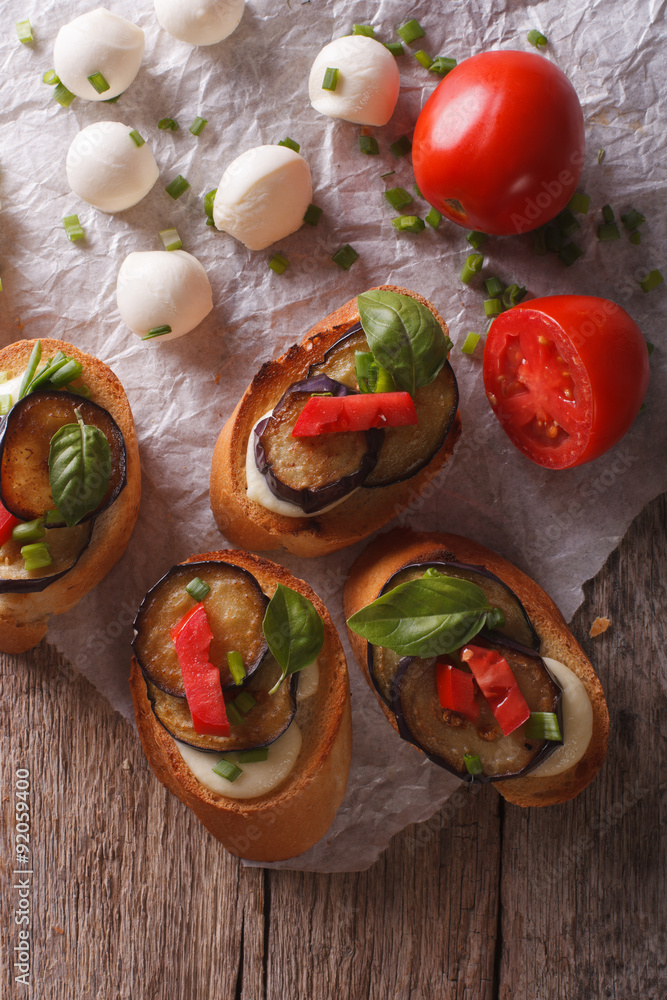 crostini with aubergine, tomato and cheese close-up. vertical top view
crostini with aubergine, tomato and cheese close-up. vertical top view