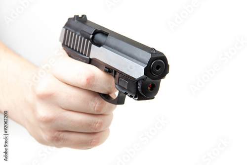 Man's hand holding gun, isolated on white.