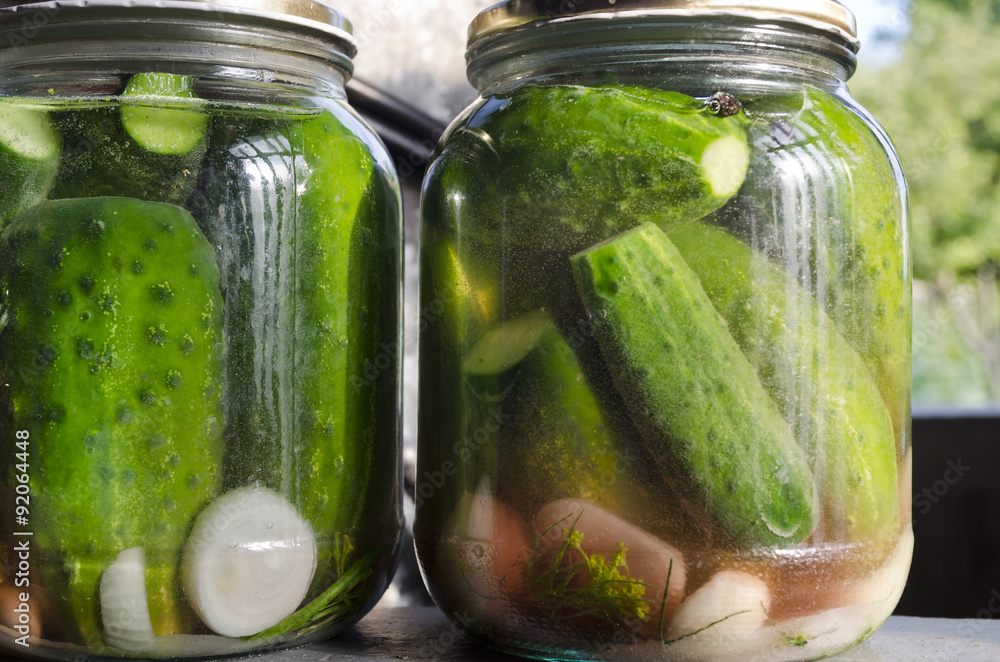 Pickled homemade cucumbers in the glass jar, preserved vegetables Pickled homemade cucumbers in the glass jar, preserved vegetables