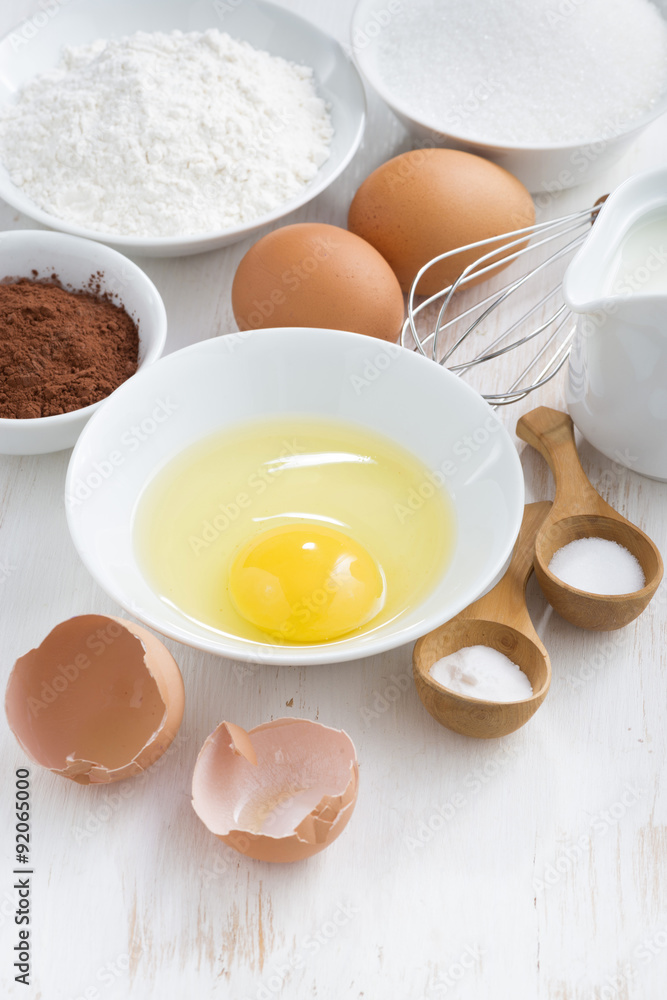 ingredients for baking on a white wooden table, vertical ingredients for baking on a white wooden table, vertical