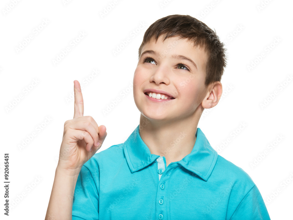Portrait of the cheerful teen boy pointing finger up Portrait of the cheerful teen boy pointing finger up