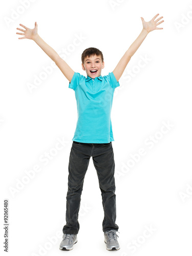 Young happy teen boy with with raised hands up. in casuals