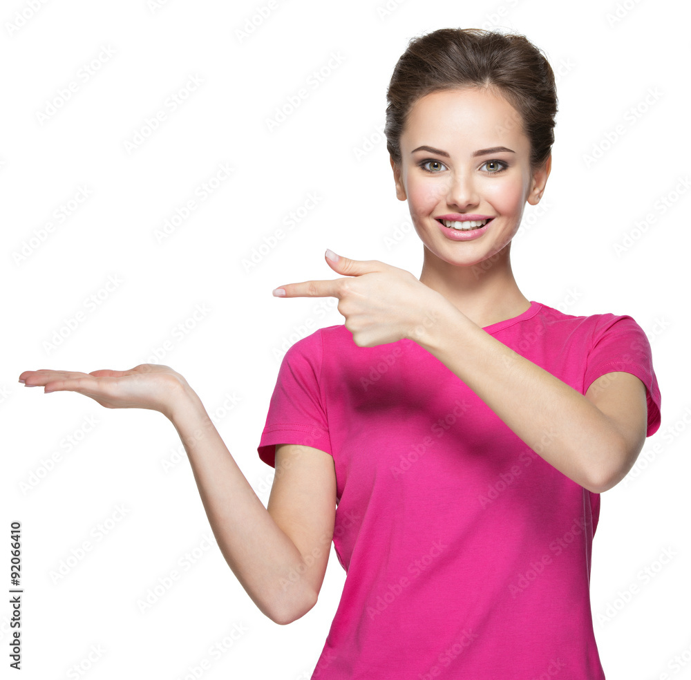 Young smiling woman points by finger on palm Young smiling woman points by finger on palm