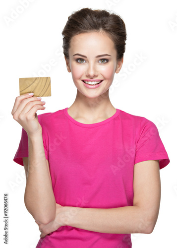 Young smiling woman holds credit card on white background