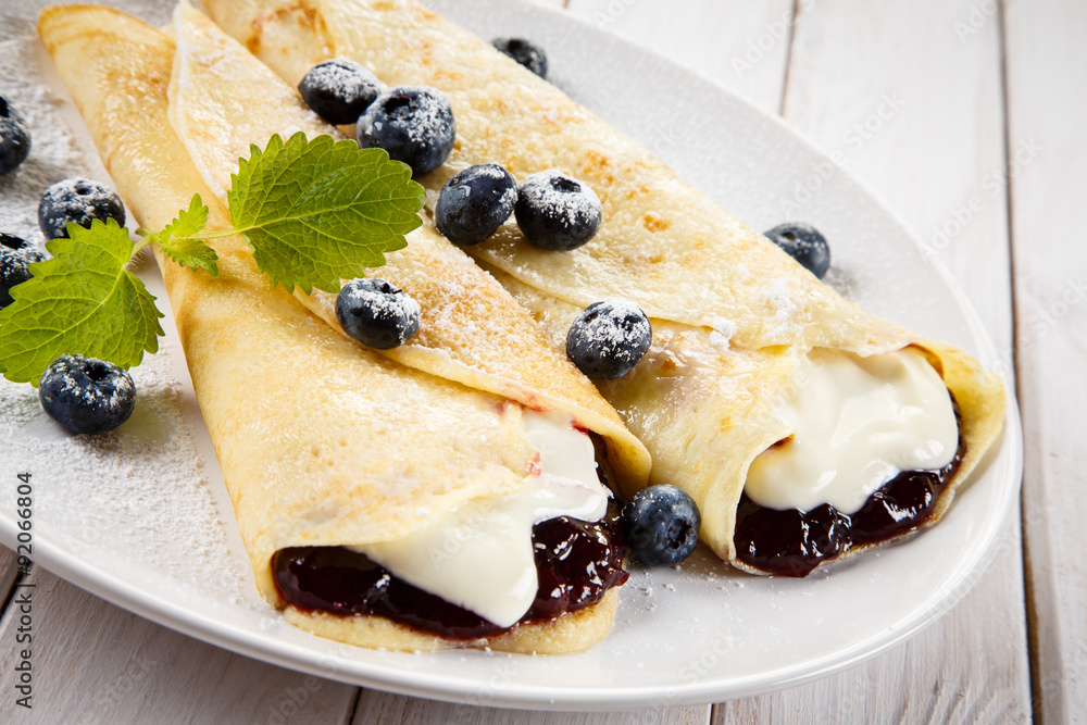 Crepes with blueberries and cream