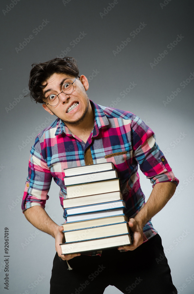 Funny student with many books Funny student with many books