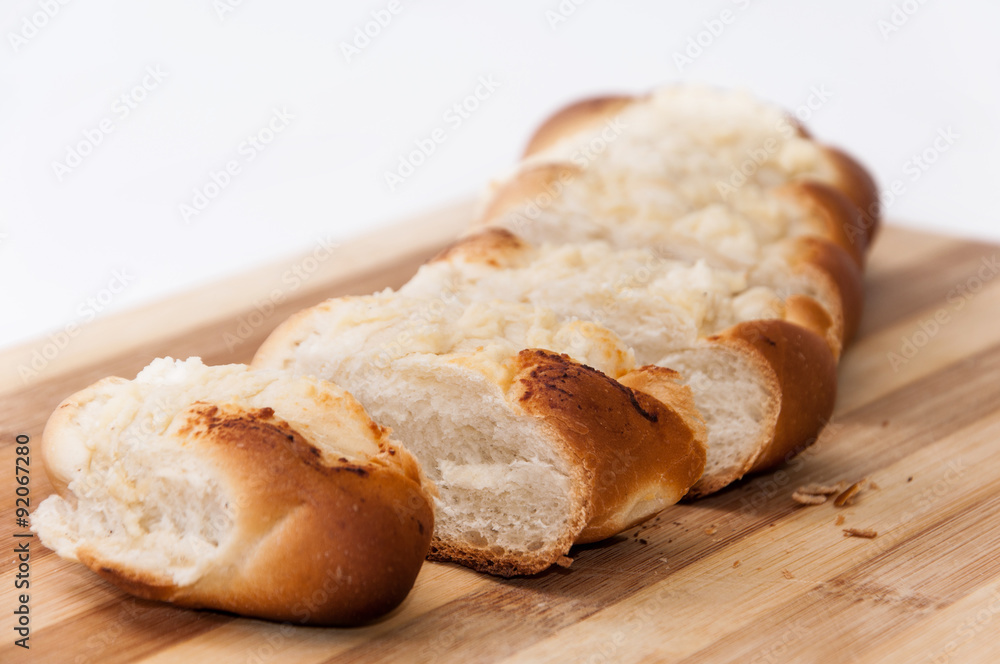 Pastry stuffed with cheese sliced on the wooden board