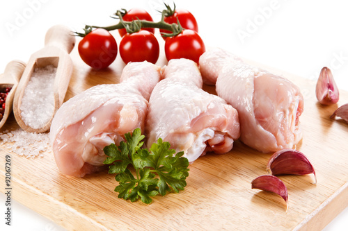 Raw chicken legs on cutting board