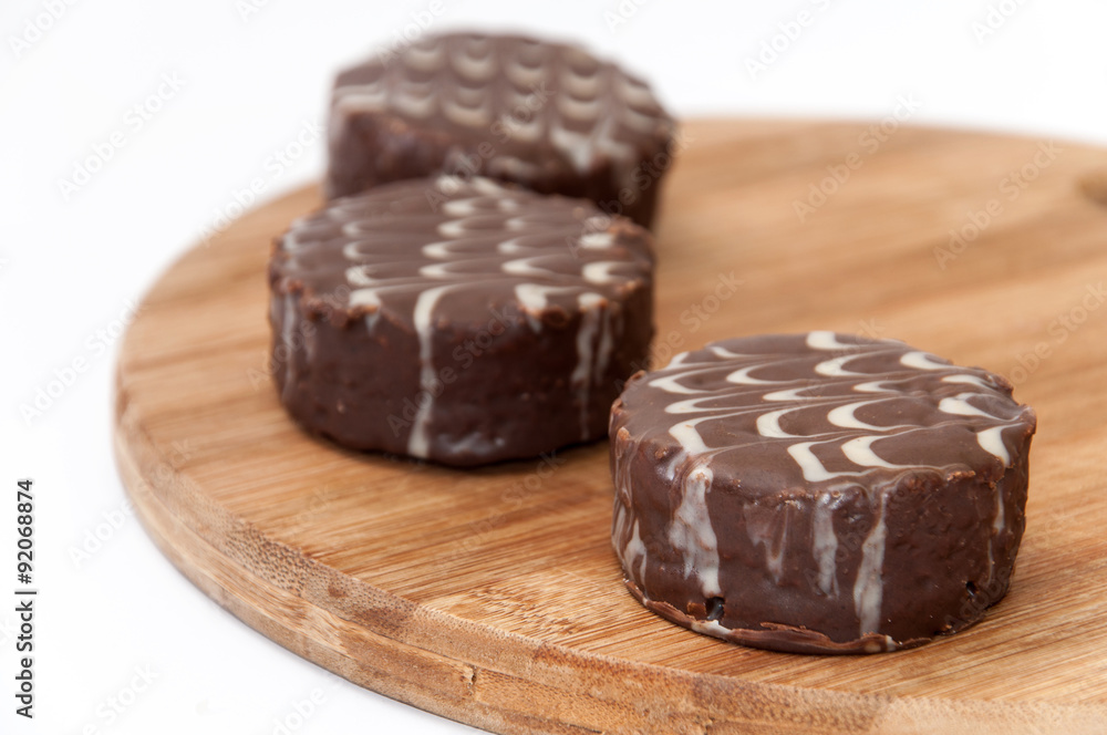 Three chocolate muffins on the wooden board Three chocolate muffins on the wooden board