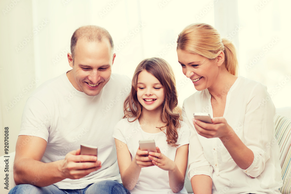 parents and little girl with smartphones at home parents and little girl with smartphones at home