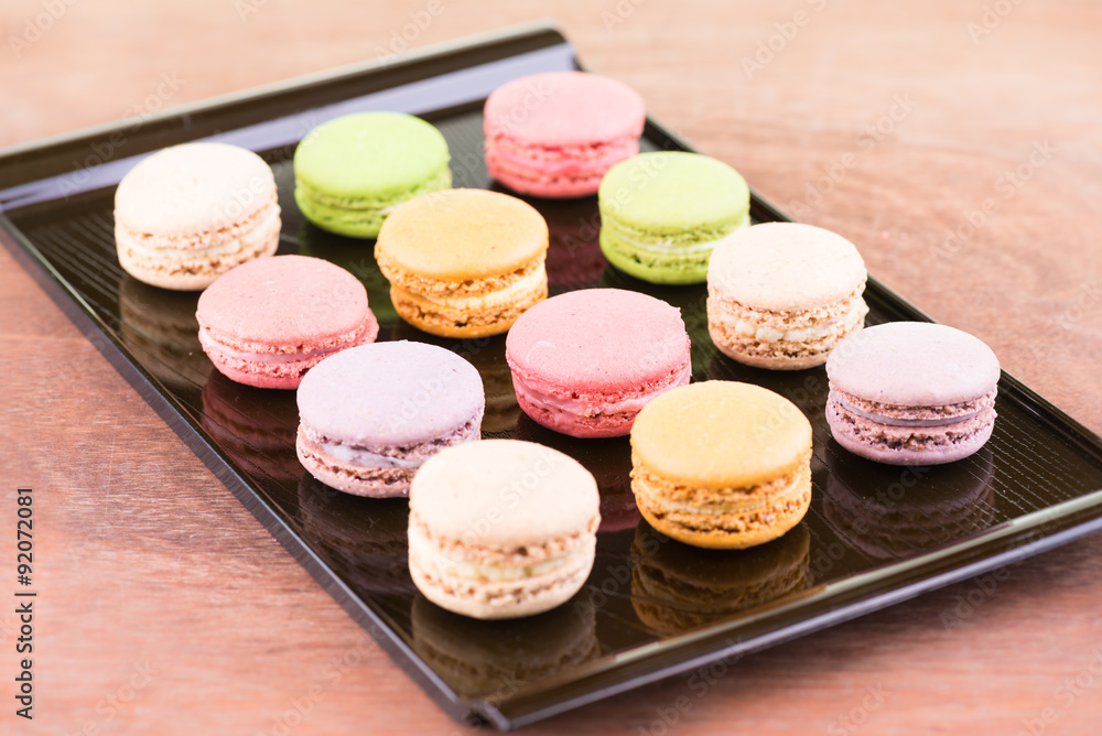 Fototapeta premium Colorful macarons on a lacquer tray