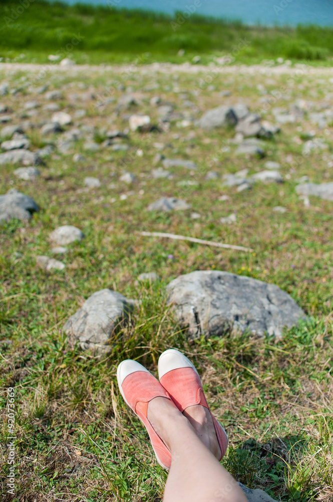 Overhead photo of feet on a background of field. Women feets Overhead photo of feet on a background of field. Women feets