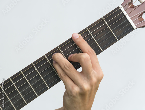  hand playing on guitar