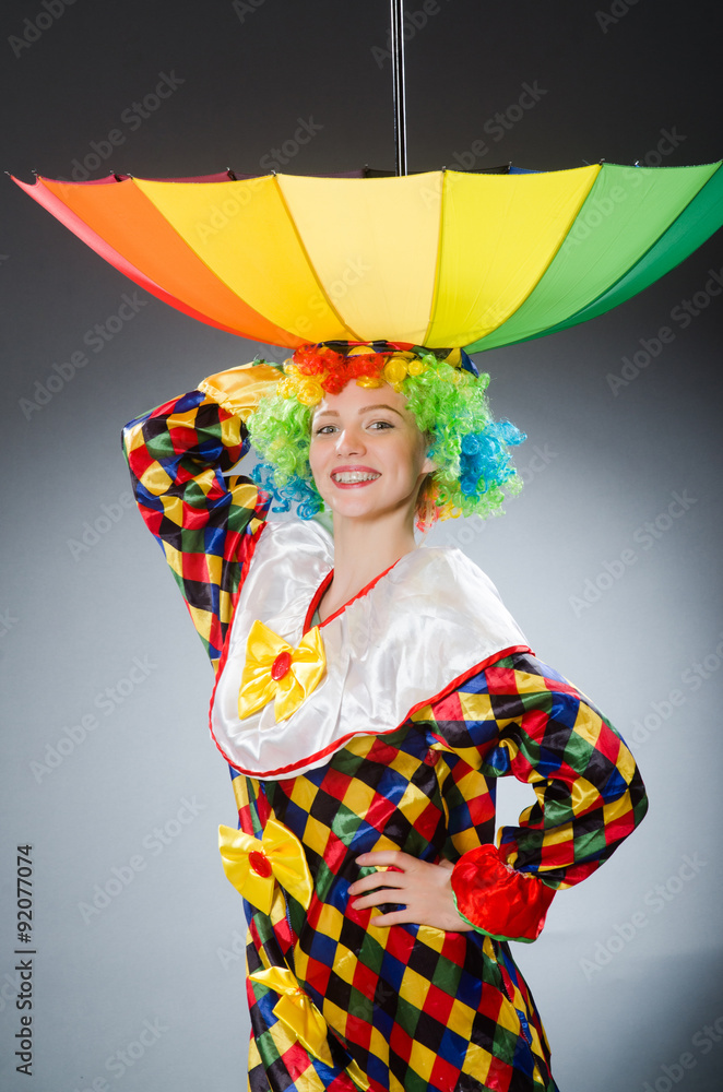 Clown with umbrella in funny concept Clown with umbrella in funny concept