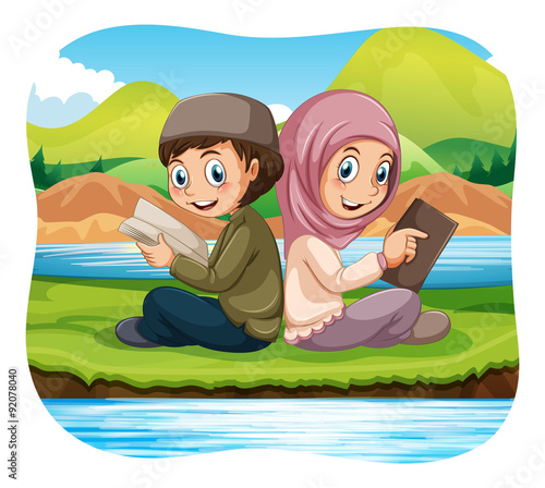 Muslim boy and girl reading in the park