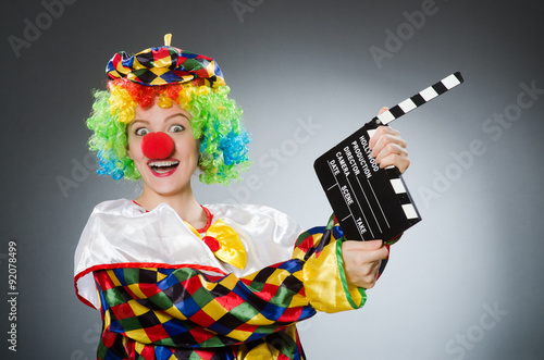 Clown with movie clapper in funny concept photo