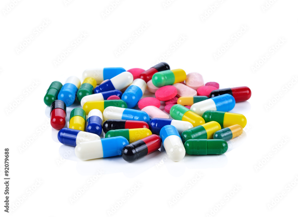 Colored pills, tablets and capsules on a white background Colored pills, tablets and capsules on a white background