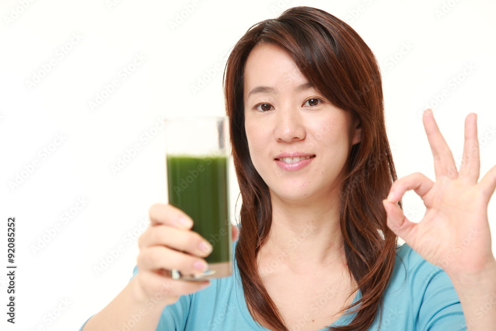 Japanese woman with green vegetable juice Japanese woman with green vegetable juice