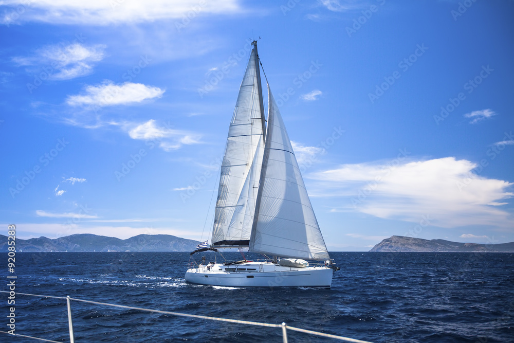 Obraz premium Sailing. Yacht sails with beautiful cloudless sky. Luxury yacht.