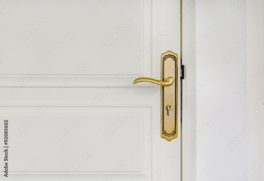 Obraz premium classic golden door handle on white door